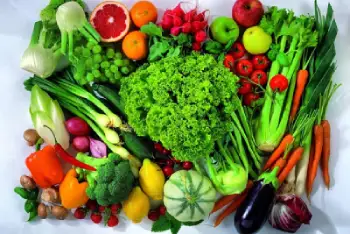 A colorful variety of fresh fruits and vegetables like broccoli, carrots, apples, and peppers spread out on a white background for healthy stomach.
