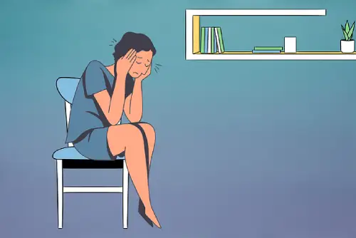 An illustration of a person sitting on a chair holding their head because it feels hurt with a small ache.