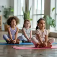 A young child with eyes closed meditating in butterfly pose on a pink mat.